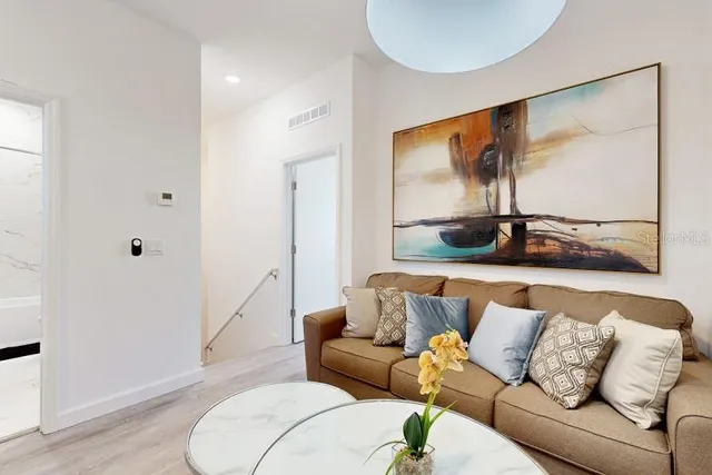 a living room with a couch and a floor to ceiling window