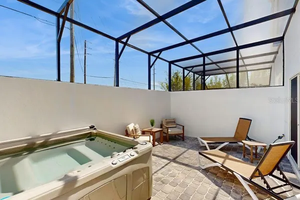 a house with lawn chairs and wooden floor