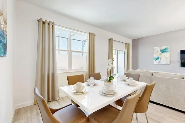 a view of a dining room with furniture and wooden floor
