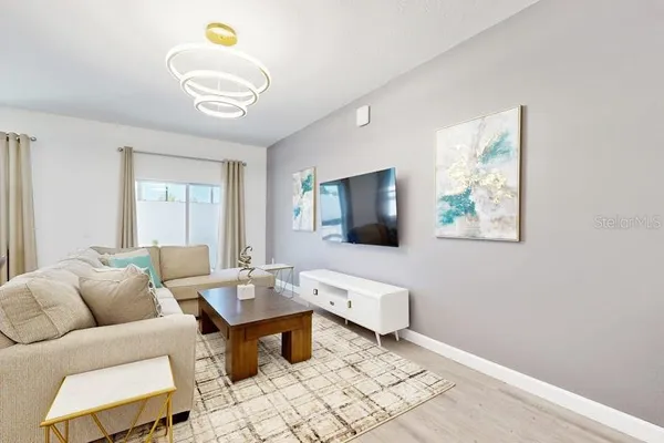 a living room with furniture and a flat screen tv