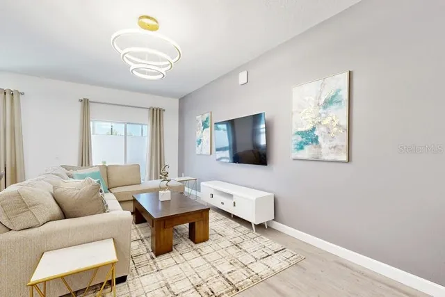 a living room with furniture and a flat screen tv