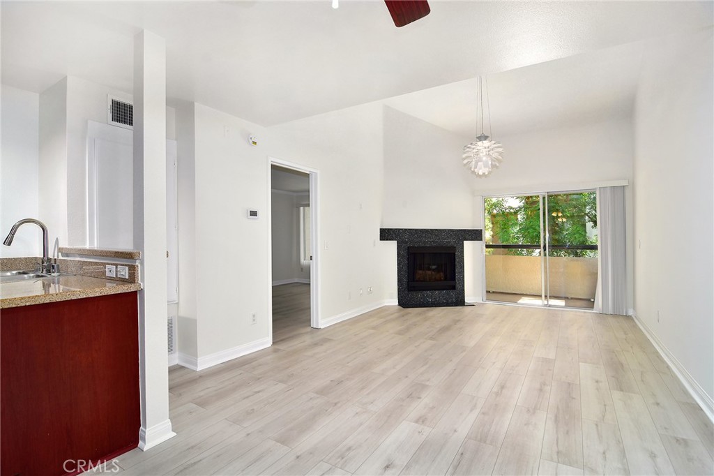 5510 Owensmouth Avenue, Unit 301 Woodland Hills, CA 91367 - Photo 1 of 22 a view of a livingroom with a fireplace and window