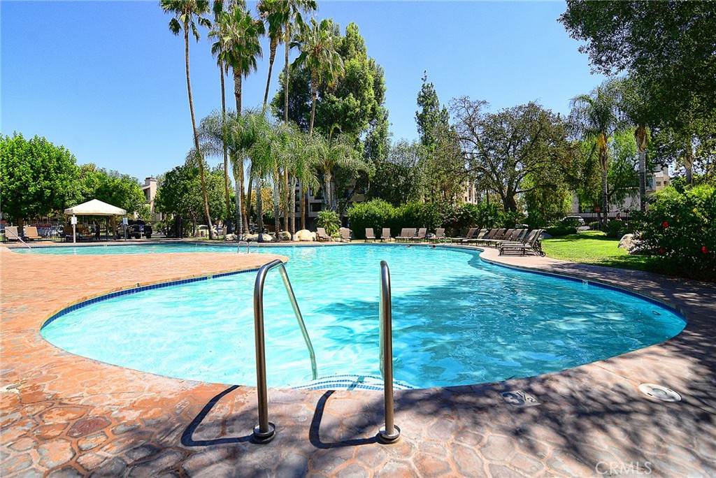 5510 Owensmouth Avenue, Unit 301 Woodland Hills, CA 91367 - Photo 12 of 22 a view of a swimming pool with a patio and plants