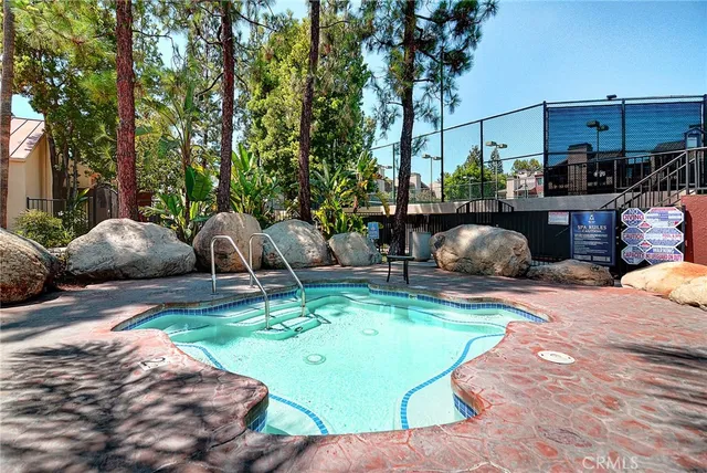 a view of a backyard with couches chair and fire pit