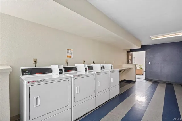 a utility room with cabinets washer and dryer