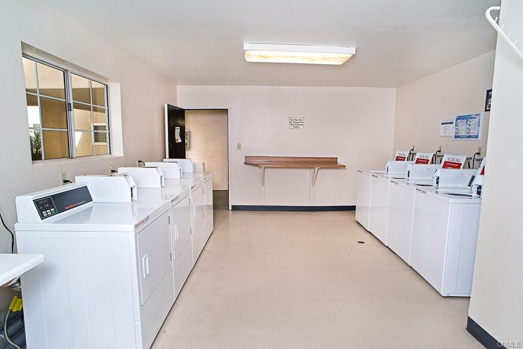 5510 Owensmouth Avenue, Unit 301 Woodland Hills, CA 91367 - Photo 21 of 22 a utility room with cabinets washer and dryer