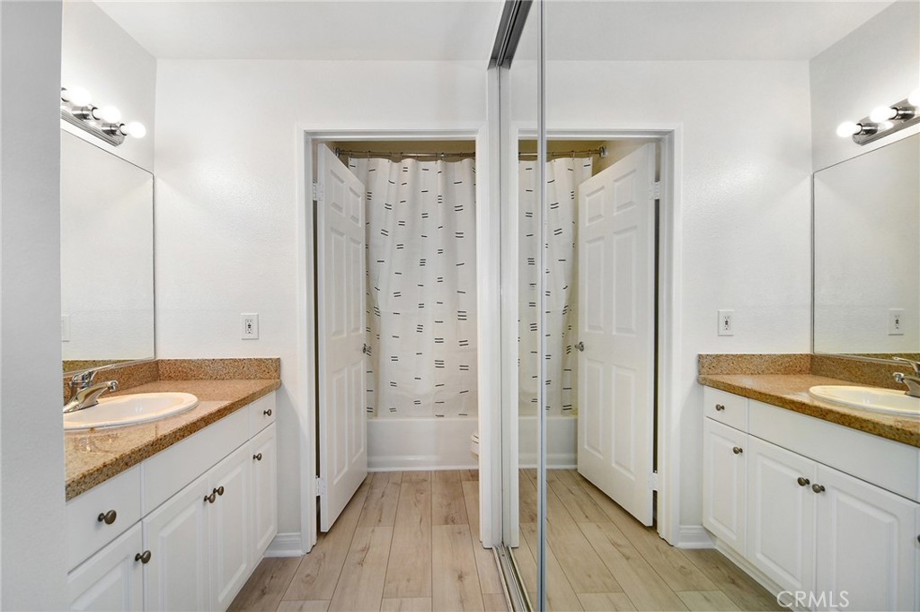 5510 Owensmouth Avenue, Unit 301 Woodland Hills, CA 91367 - Photo 8 of 22 a spacious bathroom with a granite countertop sink mirror and shower