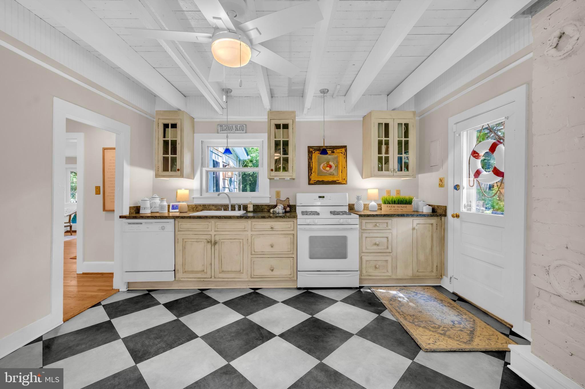 21424 Wharf Road Tilghman, MD 21671 - Photo 12 of 47 a kitchen with a checkered floor and white appliances