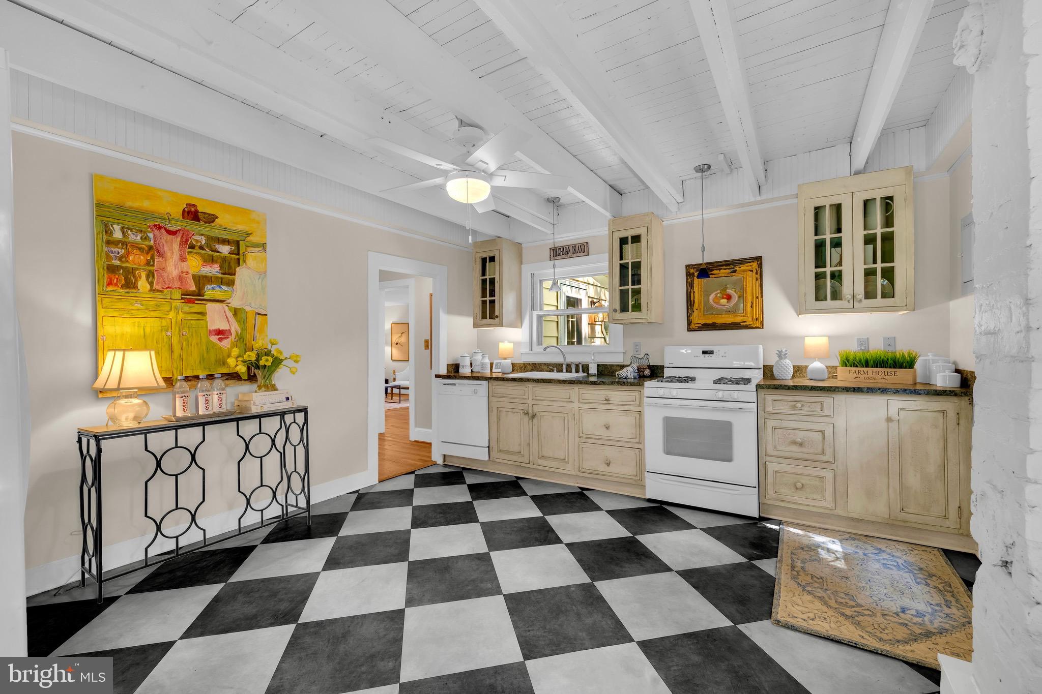 21424 Wharf Road Tilghman, MD 21671 - Photo 13 of 47 a kitchen with granite countertop white cabinets and appliances