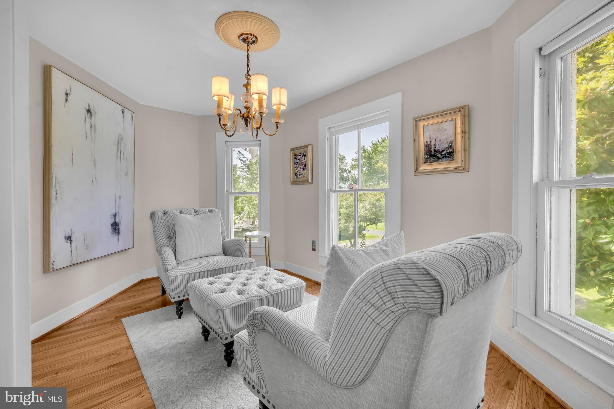 21424 Wharf Road Tilghman, MD 21671 - Photo 19 of 47 a living room with furniture and a chandelier