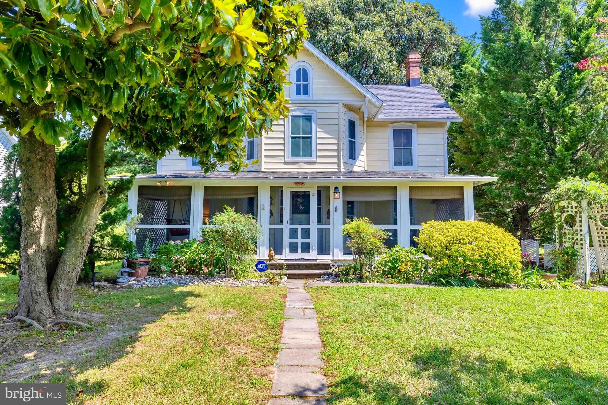 21424 Wharf Road Tilghman, MD 21671 - Photo 2 of 47 a front view of a house with garden and porch