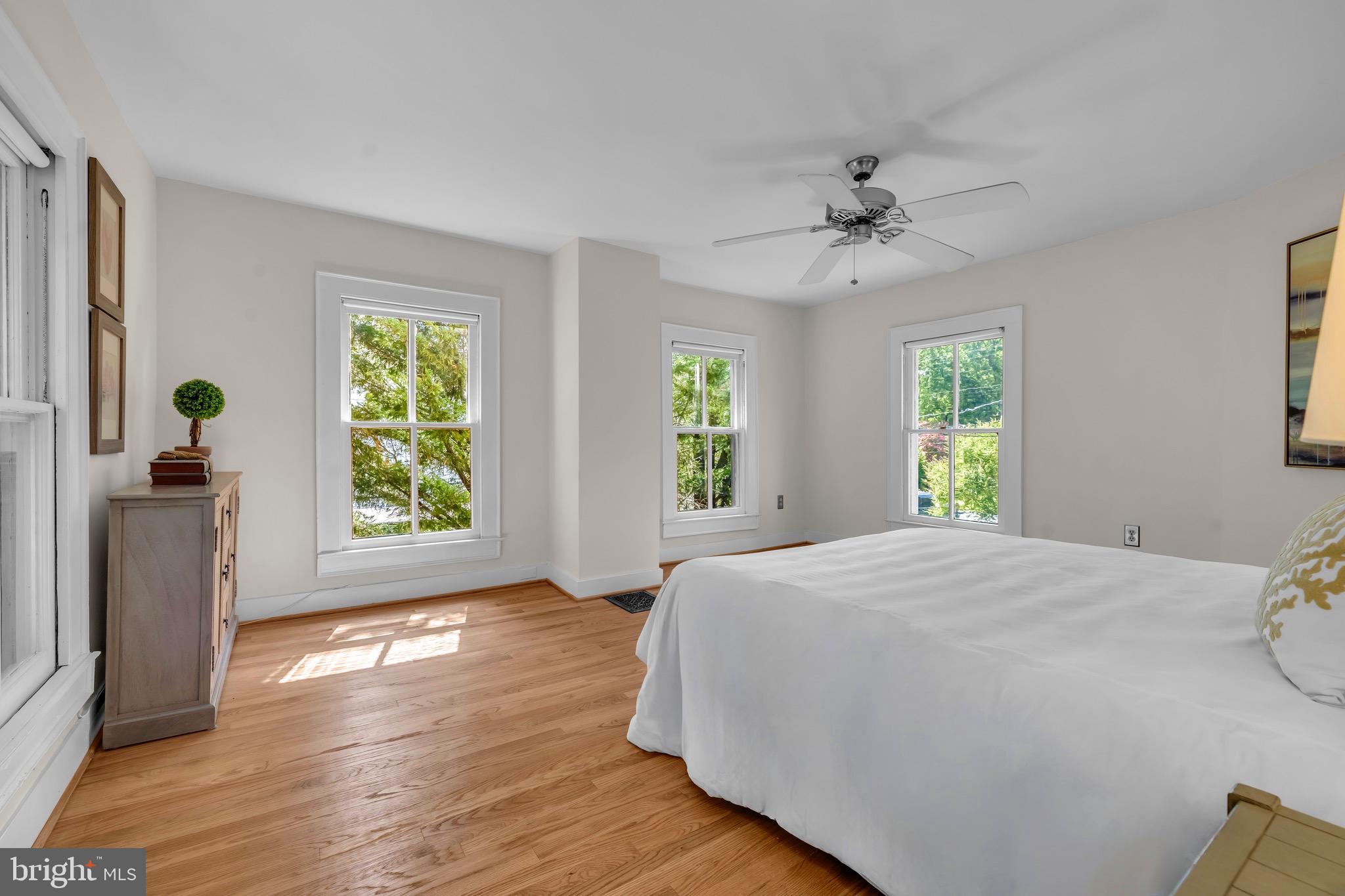 21424 Wharf Road Tilghman, MD 21671 - Photo 22 of 47 a spacious bedroom with a bed and a chandelier