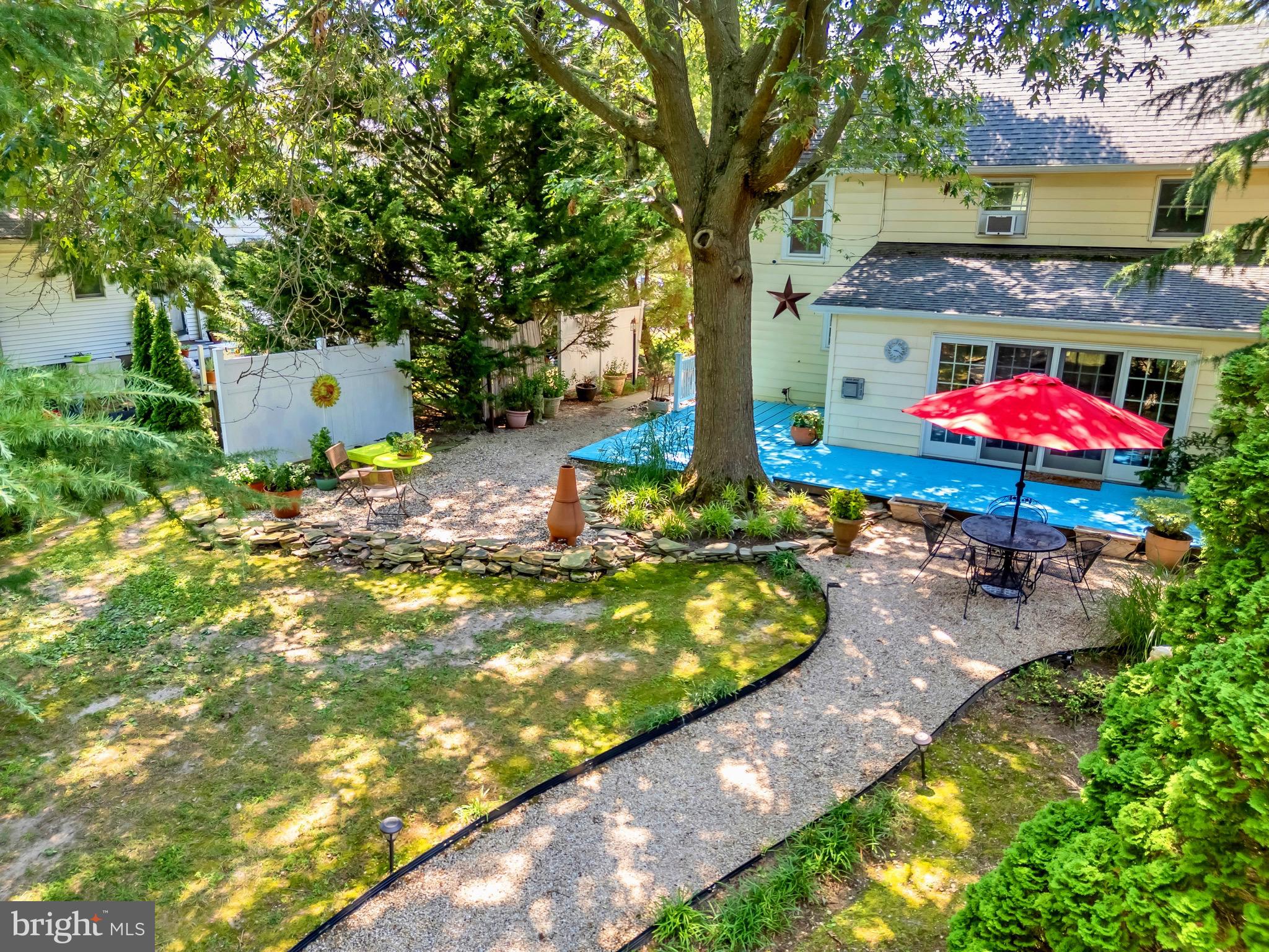 21424 Wharf Road Tilghman, MD 21671 - Photo 39 of 47 a backyard of a house with yard and outdoor seating