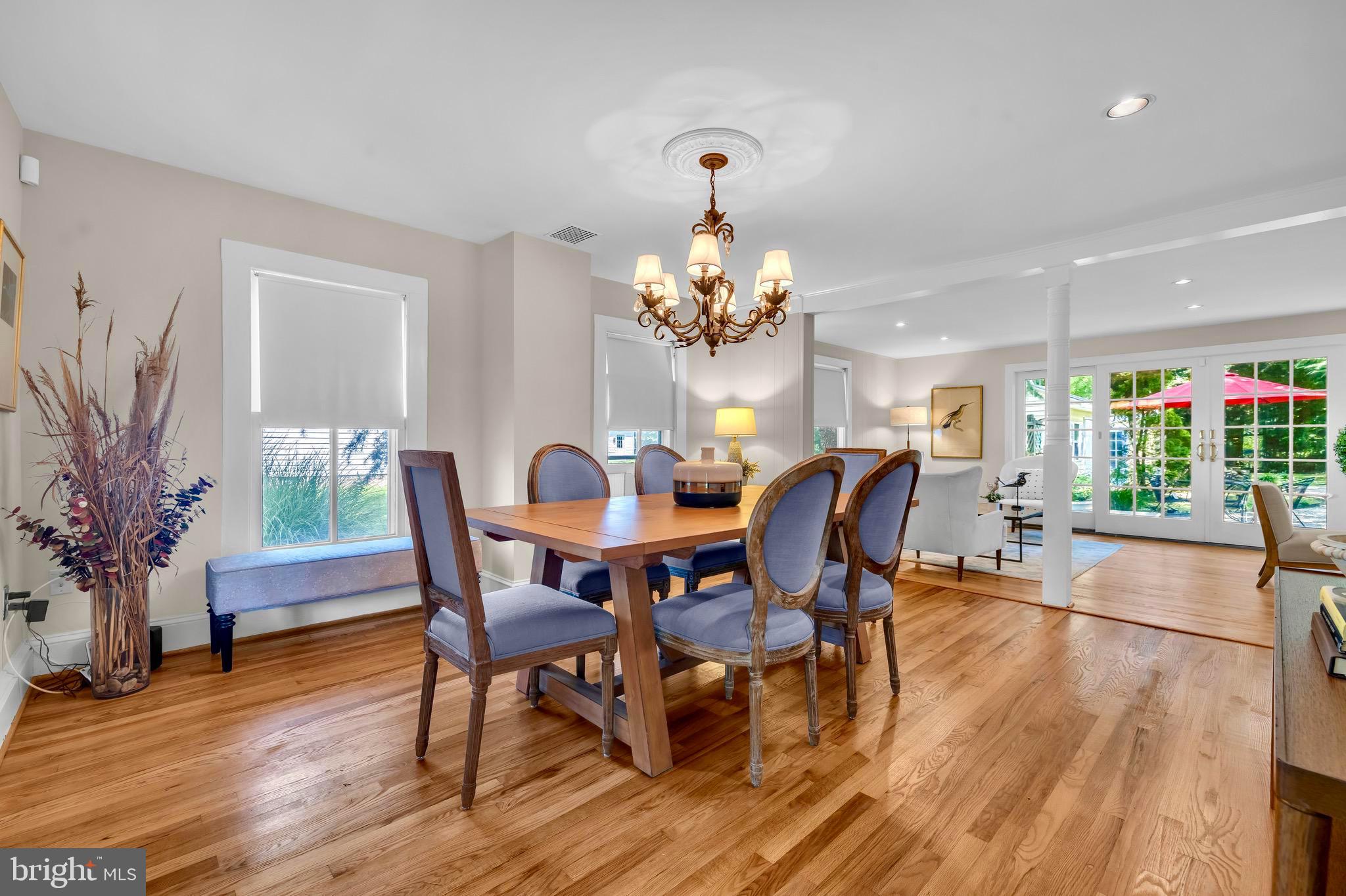 21424 Wharf Road Tilghman, MD 21671 - Photo 8 of 47 a dining room with furniture potted plants and wooden floor