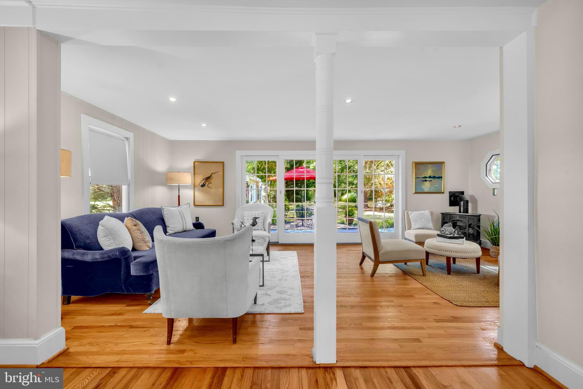 21424 Wharf Road Tilghman, MD 21671 - Photo 9 of 47 a living room with fireplace furniture and a wooden floor
