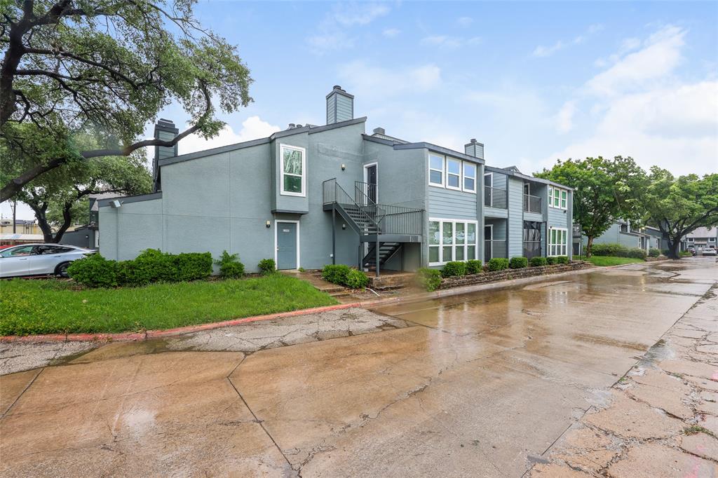 9696 Walnut Street, Unit 1216 Dallas, TX 75243 - Photo 15 of 16 Exterior building featuring gray siding, white-framed windows, and dark trim