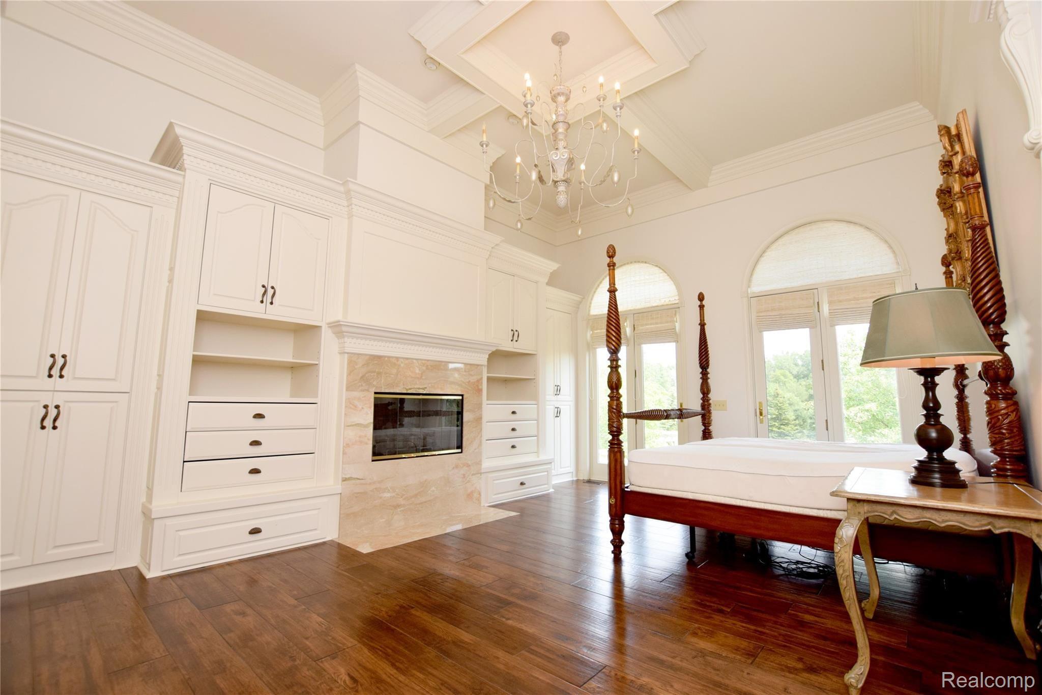 11471 Sharp Road Linden, MI 48451 - Photo 13 of 38 Master bedroom with fireplace & wall of built in shoe cabinets. Beautiful coffered ceiling.