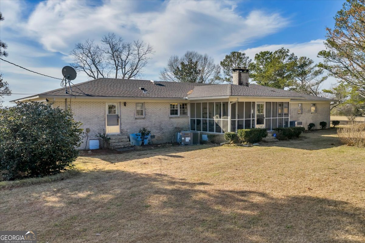 412 Red Dog Farm Road Cochran, GA 31014 - Photo 58 of 76 a view of a house with backyard and sitting area