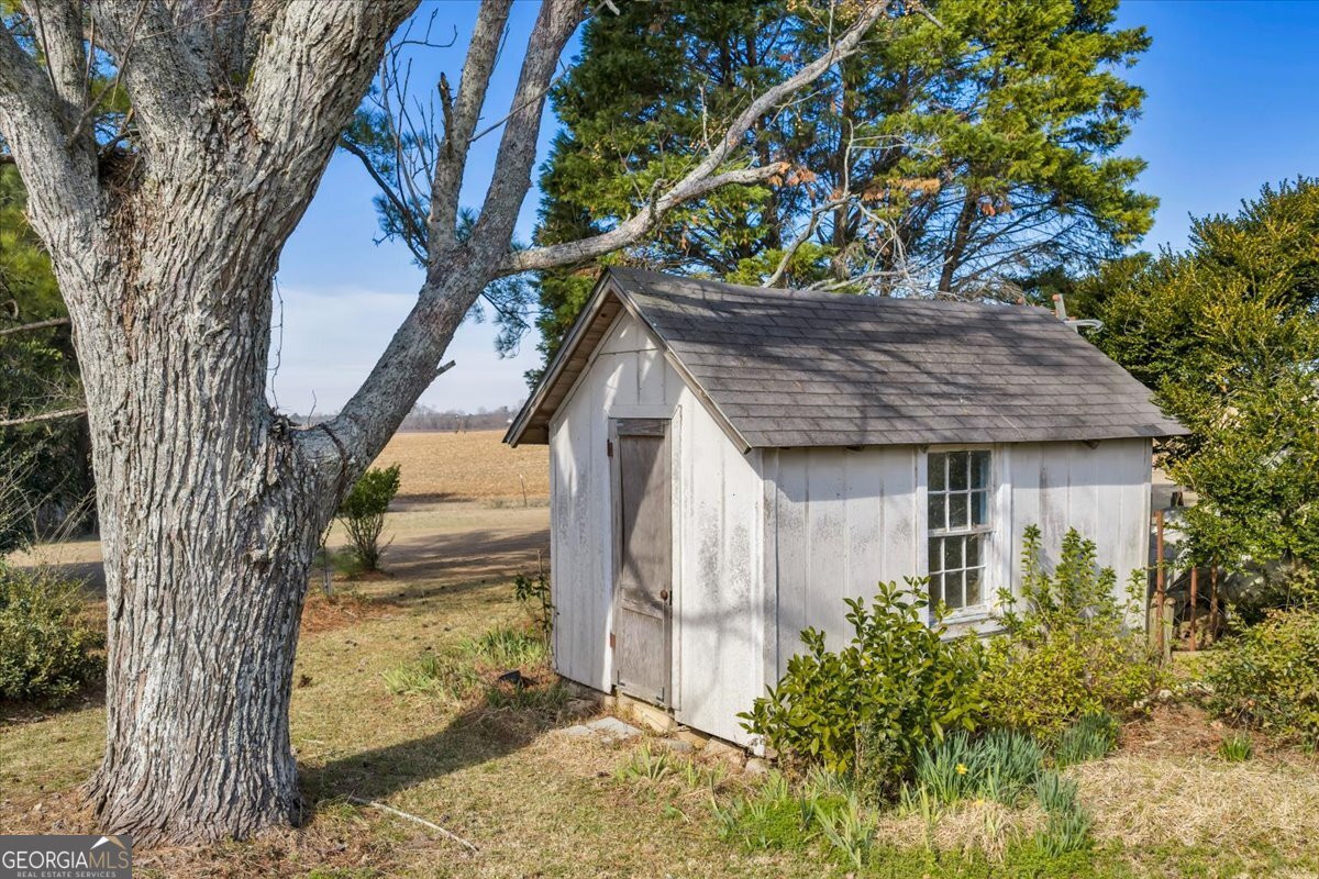 412 Red Dog Farm Road Cochran, GA 31014 - Photo 62 of 76 a view of a house with a tree next to a yard
