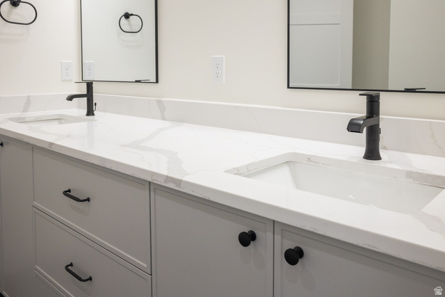 3322 250 S Street Vernal, UT 84078 - Photo 16 of 37 Dual vanity featuring white countertops with subtle veining, undermount sinks, and matte black fixtures
