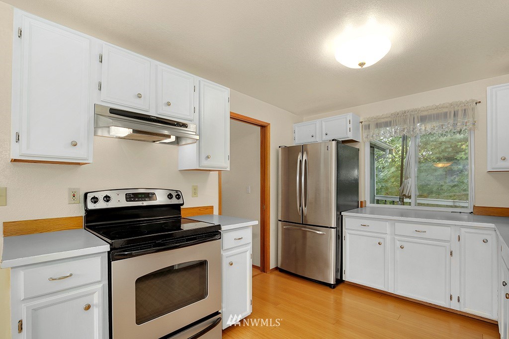 22526 14th Place West Bothell, WA 98021 - Photo 14 of 25 a kitchen with appliances a sink and cabinets