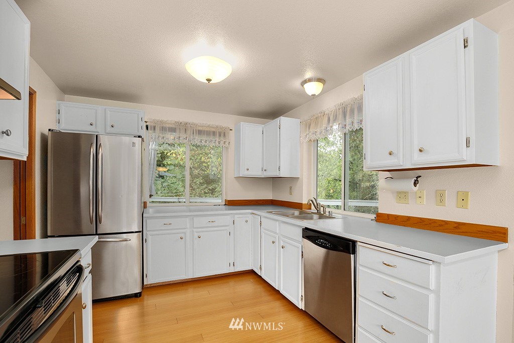 22526 14th Place West Bothell, WA 98021 - Photo 15 of 25 a kitchen with a refrigerator sink and cabinets