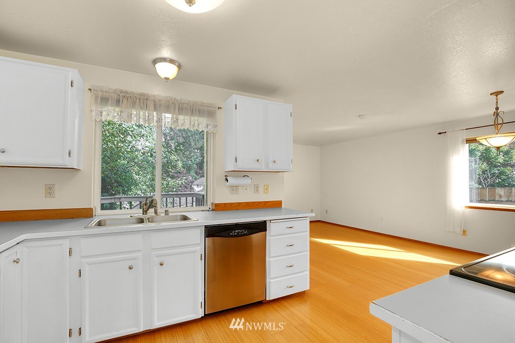 22526 14th Place West Bothell, WA 98021 - Photo 16 of 25 a kitchen with white cabinets and window