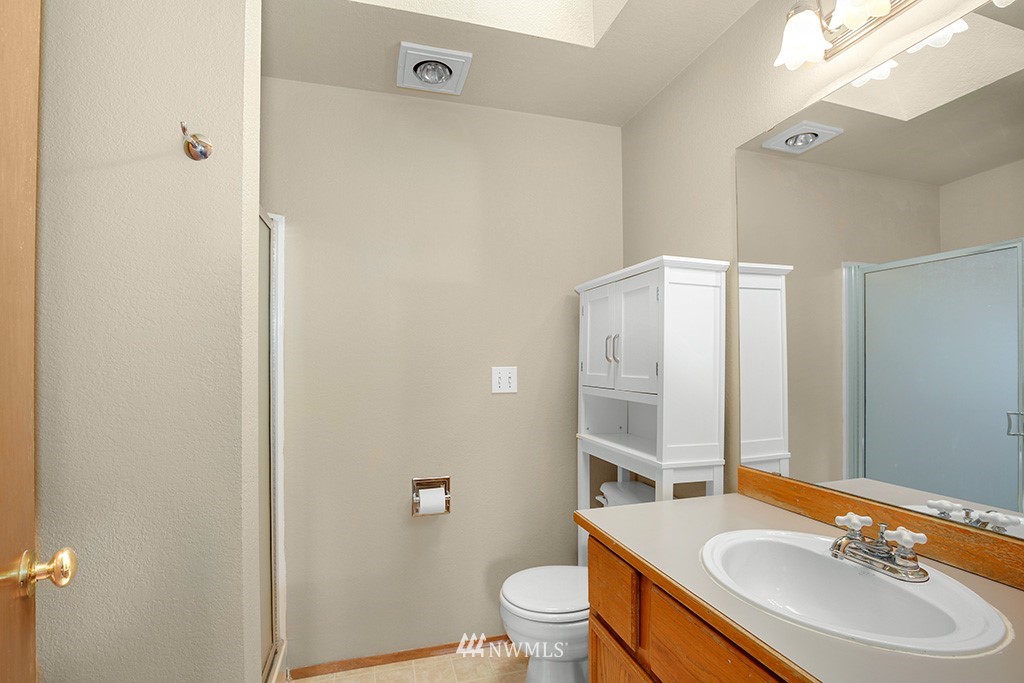 22526 14th Place West Bothell, WA 98021 - Photo 5 of 25 a bathroom with a sink a toilet a tub and a mirror