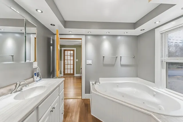 a bathroom with a granite countertop sink mirror bathtub and shower