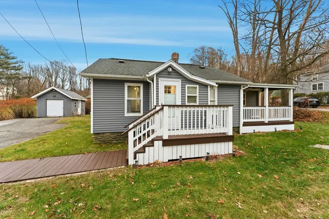 a view of a house with a yard and deck