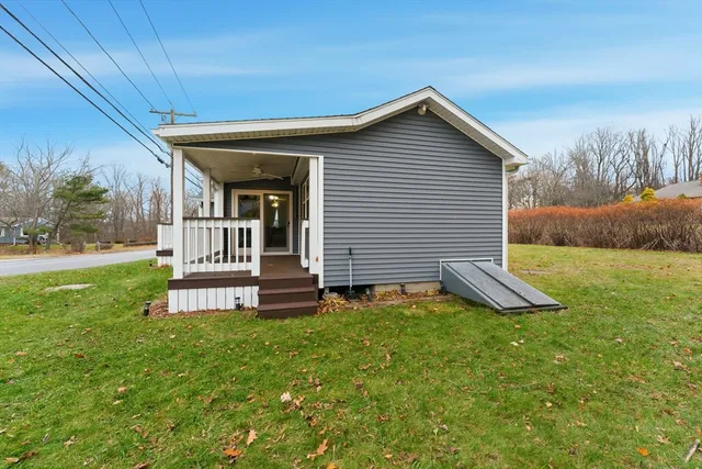 a view of a house with backyard and a garden