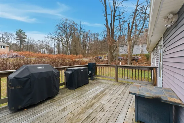 a view of a balcony with wooden floor and outdoor seating
