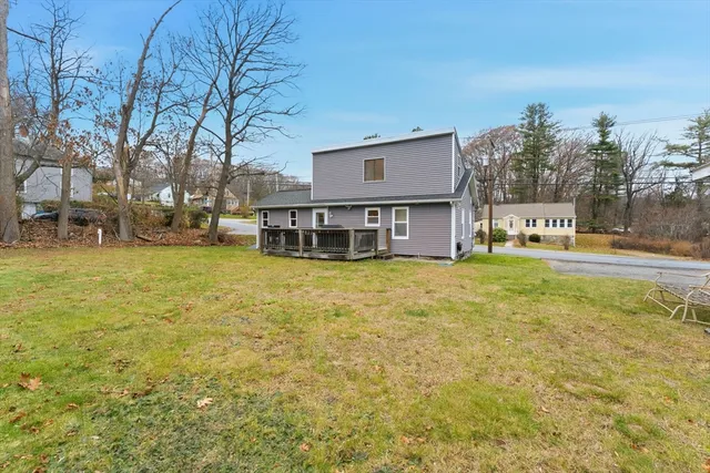 a view of a house with a yard and sitting area