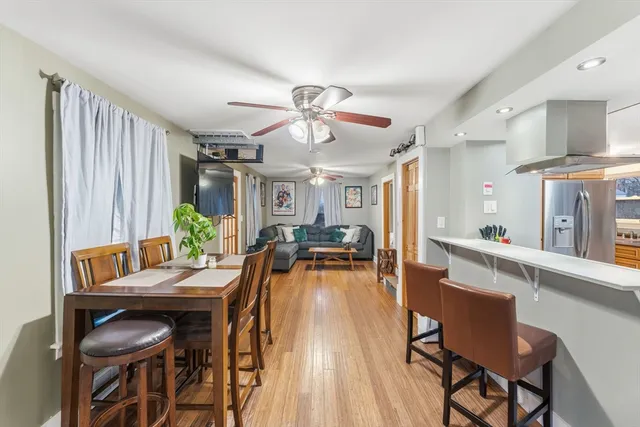 a view of a dining room with furniture window and wooden floor