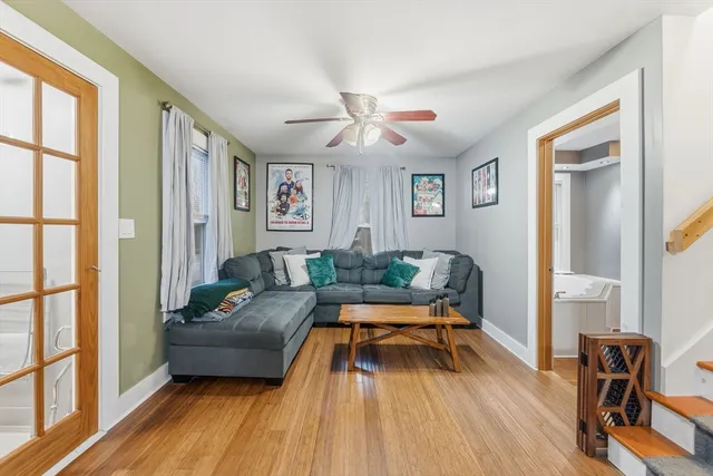 a living room with furniture and a wooden floor