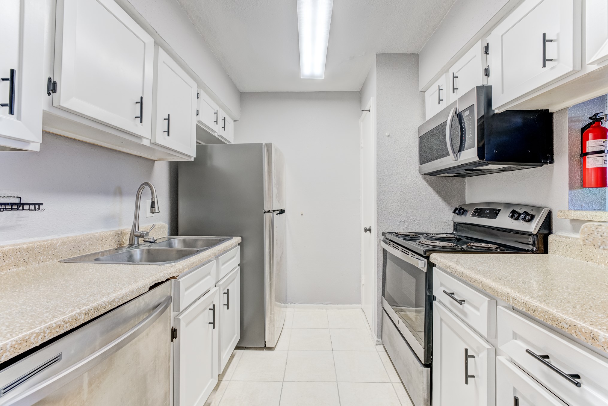 6001 Reims Road, Unit 1101 Houston, TX 77036 - Photo 20 of 35 a kitchen with stainless steel appliances granite countertop a sink stove and refrigerator