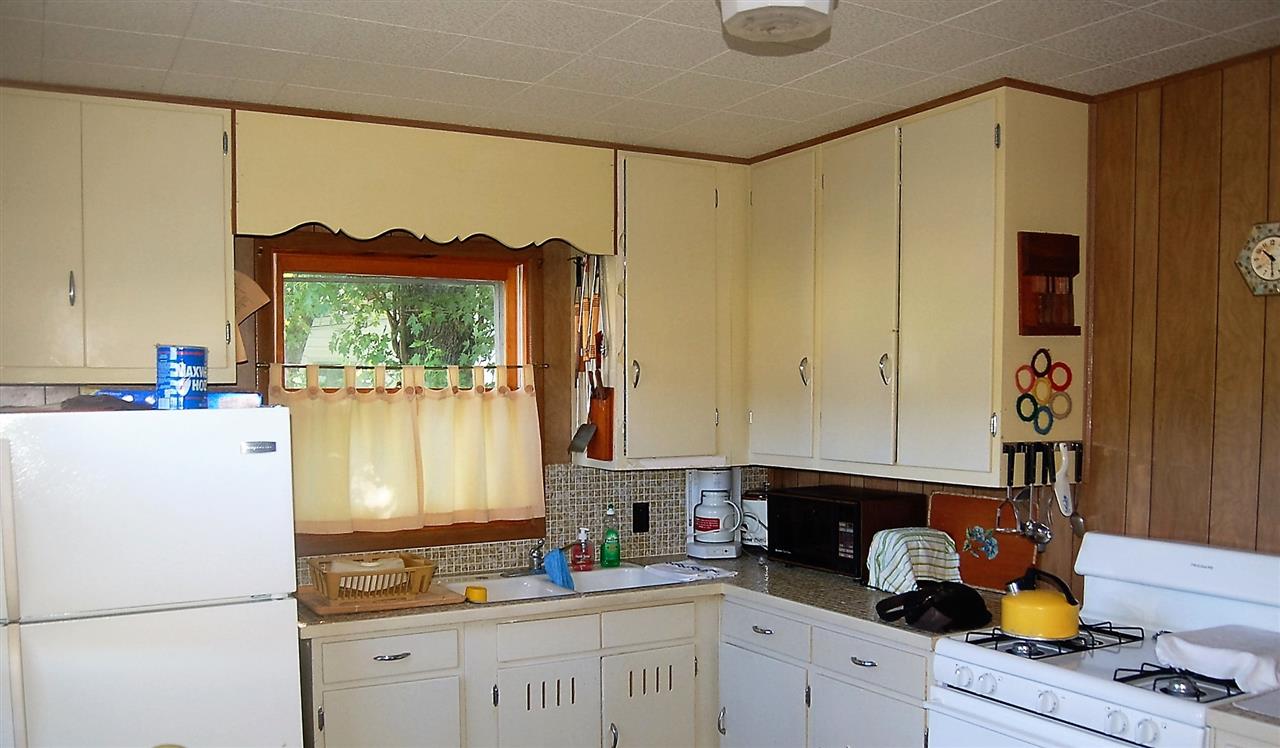 2623 South Snyder Road Oregon, IL 61061 - Photo 12 of 23 a kitchen with a refrigerator and a window