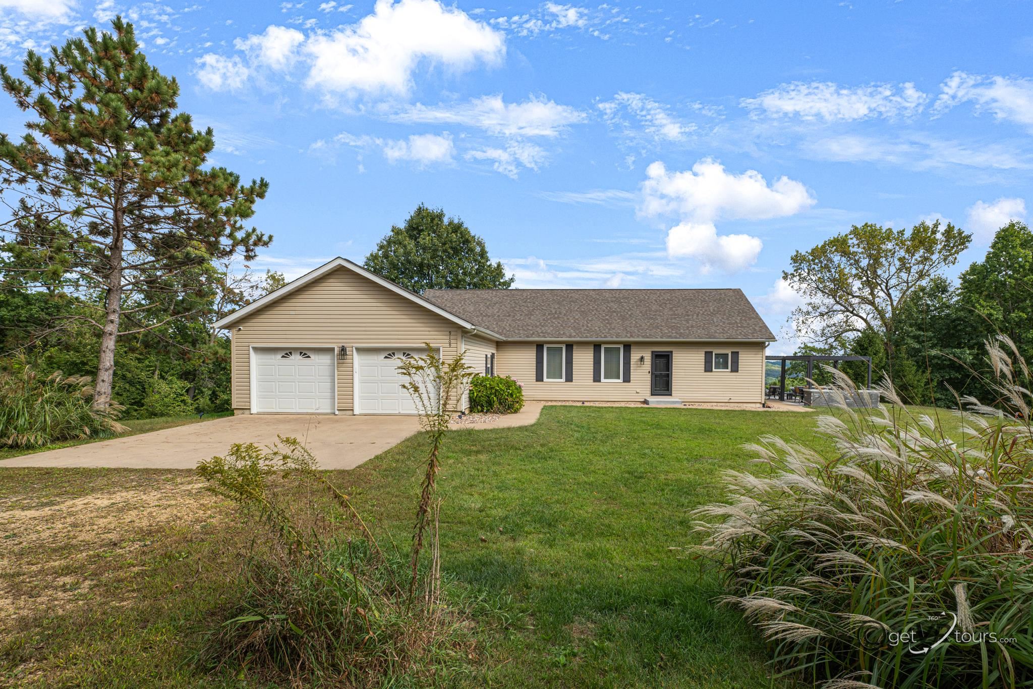 a view of a house with yard and a garden