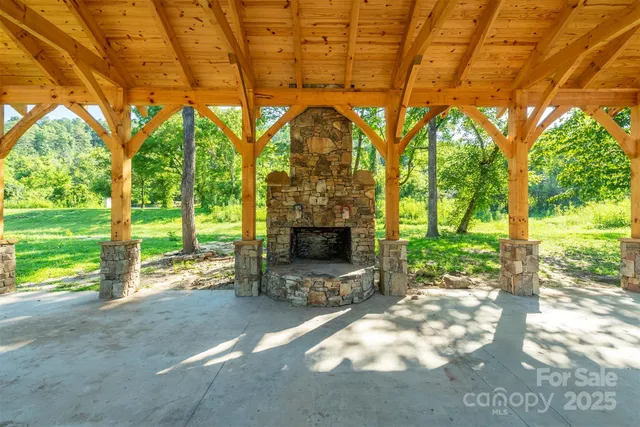 a view of a yard with large trees and a tub