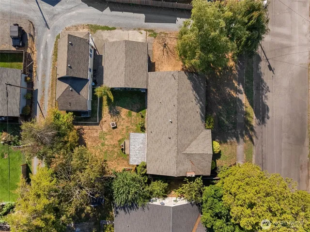 an aerial view of a house with a yard