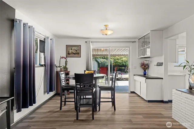 a view of a dining room with furniture window and wooden floor