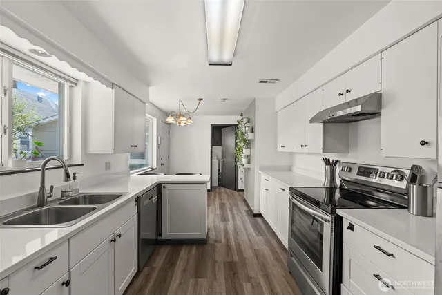 a kitchen with a stove and a sink