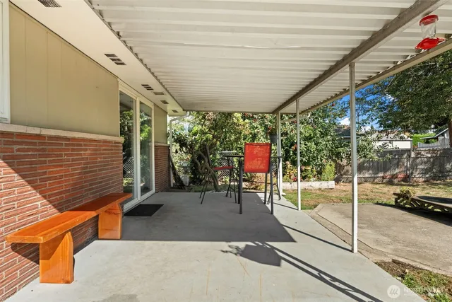 a patio with table and chairs
