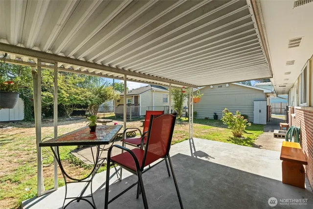 a view of a backyard with a sitting area