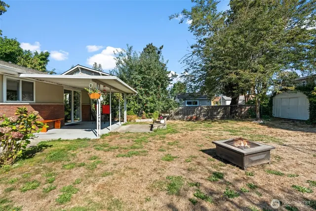 a view of a house with backyard and sitting area