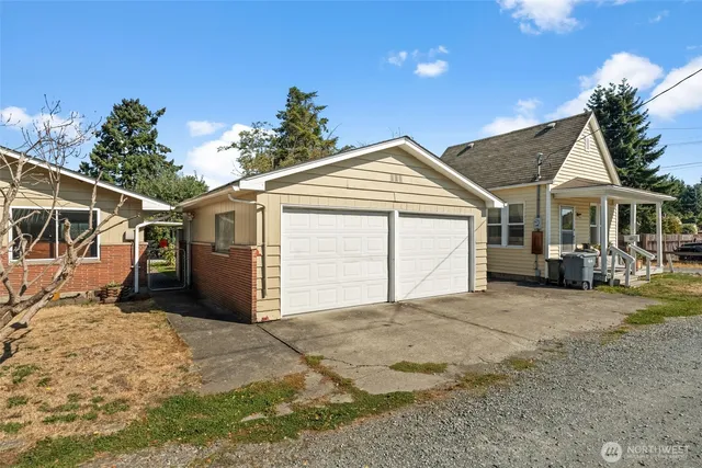 a view of a house with a yard and garage