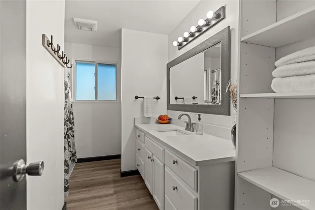 a bathroom with a sink vanity and a mirror