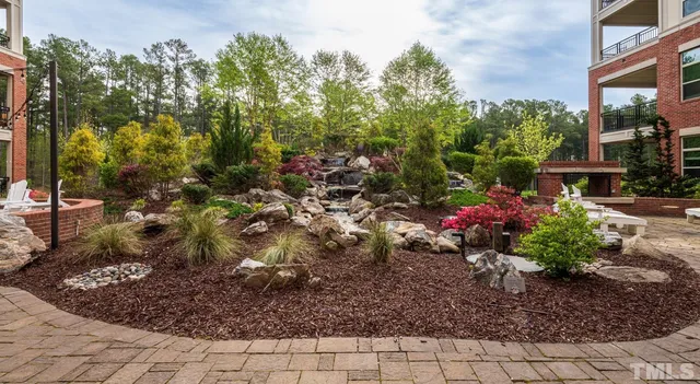 a view of a patio with table and chairs and potted plants