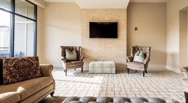 a bedroom with furniture and a flat screen tv