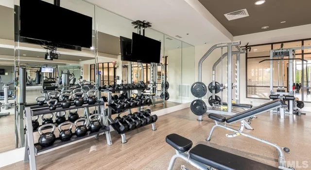 a room with gym equipment and a flat screen tv
